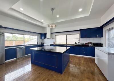 Spacious modern kitchen with blue cabinets and hardwood floors