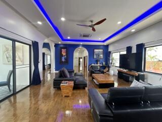 Spacious modern living room with hardwood floors and blue accent walls