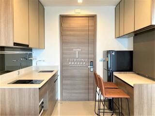 Modern kitchen with integrated appliances and breakfast bar