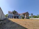 Spacious two-story house with large yard under clear sky