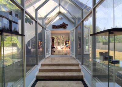 Glass enclosed entrance of a modern home leading to an open living space