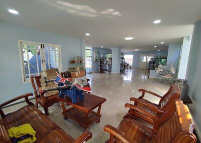 Spacious living room with wooden furniture and ample natural light