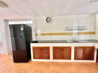 Spacious kitchen with modern appliances and tiled backsplash