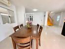 Spacious dining room with large table and staircase