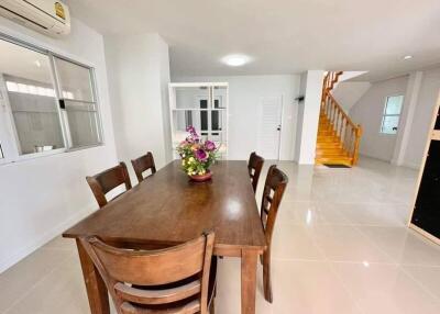 Spacious dining room with large table and staircase