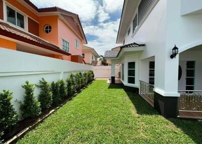 Bright and well-maintained garden area between residential homes