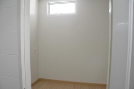 Bright empty bedroom with neutral walls and wooden flooring