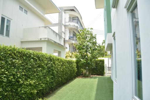 Modern residential home exterior with landscaped pathway