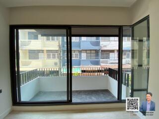 Spacious living room with large windows and balcony access