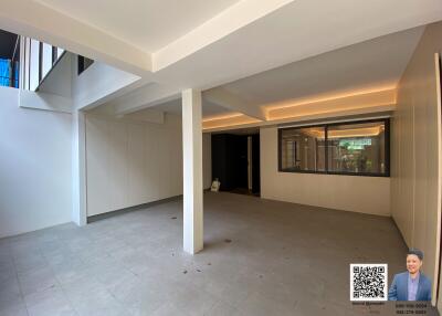 Spacious unfurnished living area with large windows and modern lighting