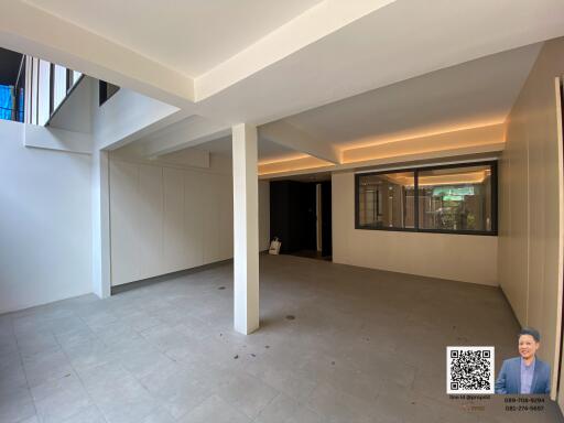 Spacious unfurnished living area with large windows and modern lighting