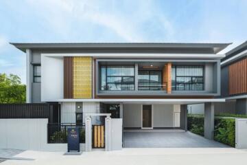 Modern two-story house with stylish facade and balcony