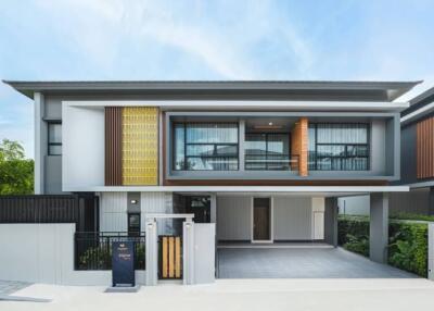 Modern two-story house with stylish facade and balcony