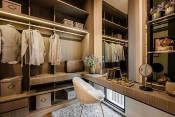 Elegant walk-in closet with custom shelving and seating area