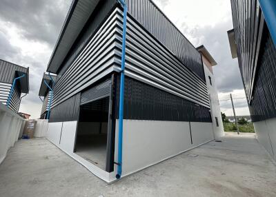 Exterior view of a modern industrial warehouse with distinctive blue and white design