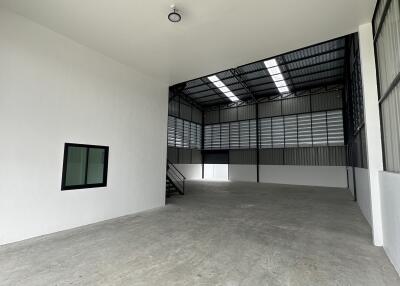 Spacious industrial warehouse with high ceiling and large windows