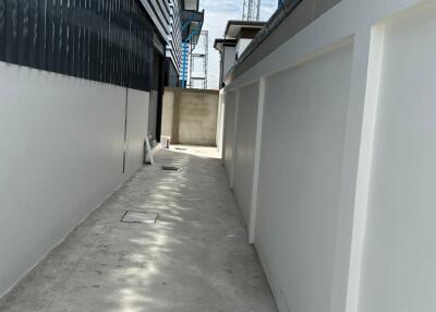 Narrow alleyway between modern building structures under construction