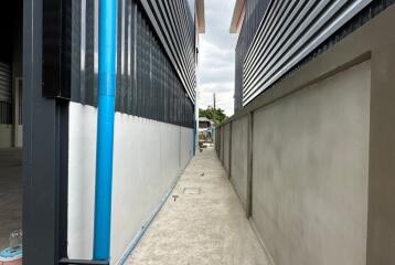 Narrow alleyway between modern industrial buildings