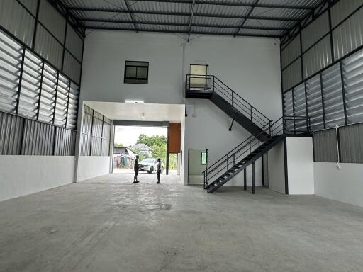 Spacious industrial warehouse interior with high ceiling and multiple storage levels