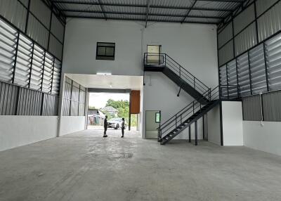 Spacious industrial warehouse interior with high ceiling and multiple storage levels