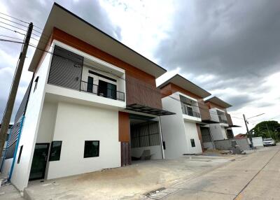 Modern two-story townhouses with balconies and stylish facade