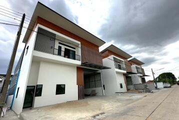 Modern two-story townhouses with balconies and stylish facade