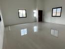 Spacious and bright empty living room with glossy tiled flooring