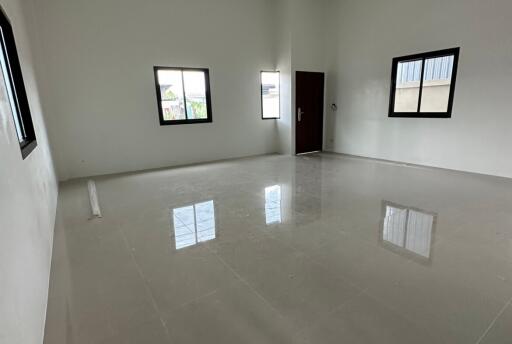 Spacious and bright empty living room with glossy tiled flooring