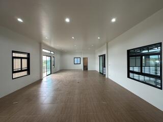 Spacious and empty living room with large windows