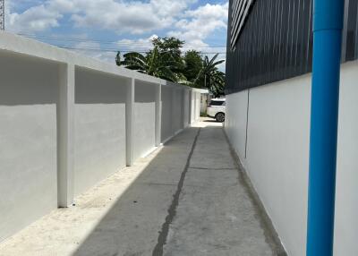 Exterior alleyway of a residential building with bright daylight