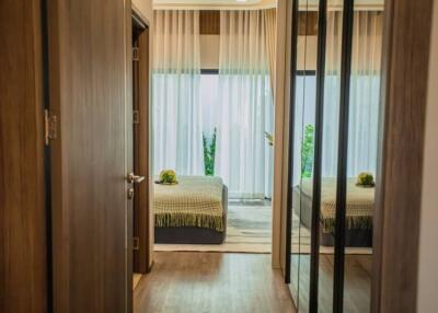 Elegant bedroom with mirrored wardrobe doors and view into garden