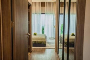 Elegant bedroom with mirrored wardrobe doors and view into garden