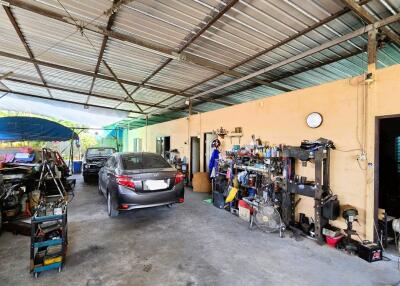 Spacious residential garage with multiple vehicles and storage shelves