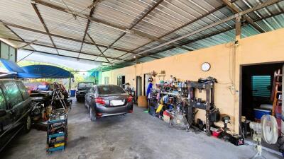 Spacious residential garage with multiple vehicles and storage shelves