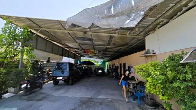 Spacious covered parking area with greenery