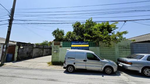 Street view of property entrance with gated access