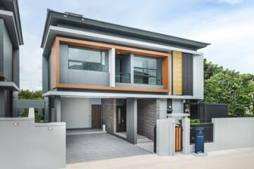 Modern two-story house with stylish grey and wood facade