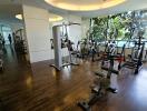 Modern gym in residential building with variety of equipment