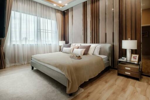 Elegant bedroom with large bed and modern wooden accents
