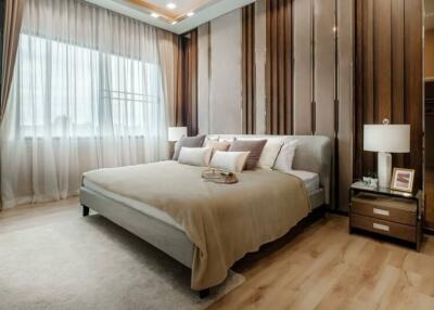 Elegant bedroom with large bed and modern wooden accents