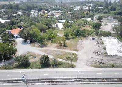 Aerial view of a developing neighborhood with visible roads, greenery and construction sites