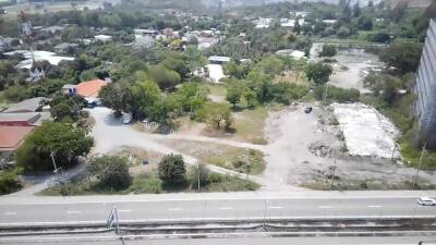 Aerial view of a developing neighborhood with visible roads, greenery and construction sites