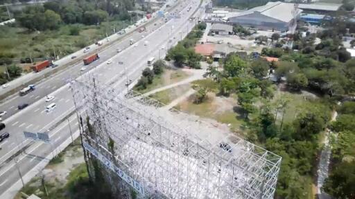 Aerial view of a large billboard structure near a busy highway