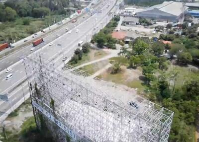 Aerial view of a large billboard structure near a busy highway