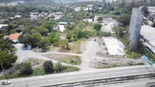 Aerial view of urban landscape showing development land, roads, and greenery