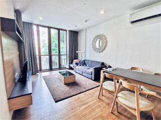 Bright and modern living room with balcony access and elegant furnishings