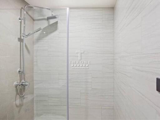 Modern bathroom with glass shower door and elegant tiling