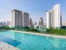 Luxurious outdoor swimming pool with city skyline and high-rise buildings