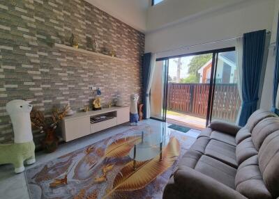Spacious and well-lit living room with modern decor and outdoor access