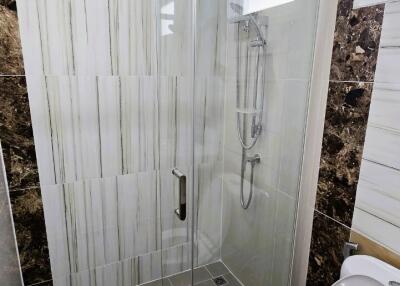 Modern bathroom interior with glass shower and toilet